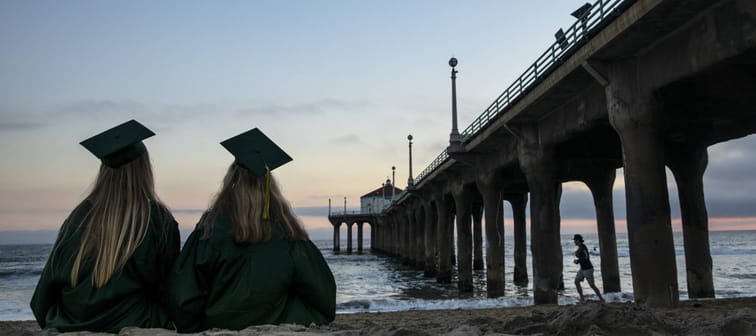 Graduates in cap and gown celebrate at Manhattan Beach Pier, Los Angeles
