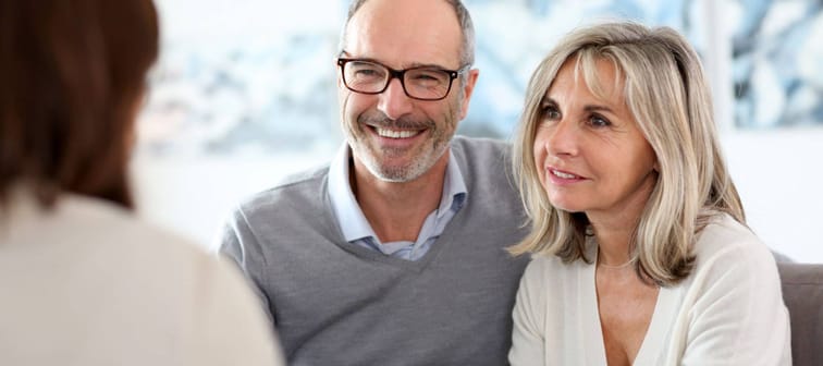 Couple meeting financial adviser to enquire about senior checking accounts