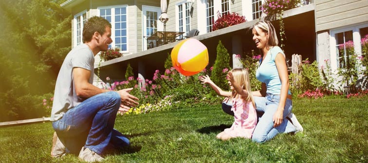 Happy smiling family with child over  house background